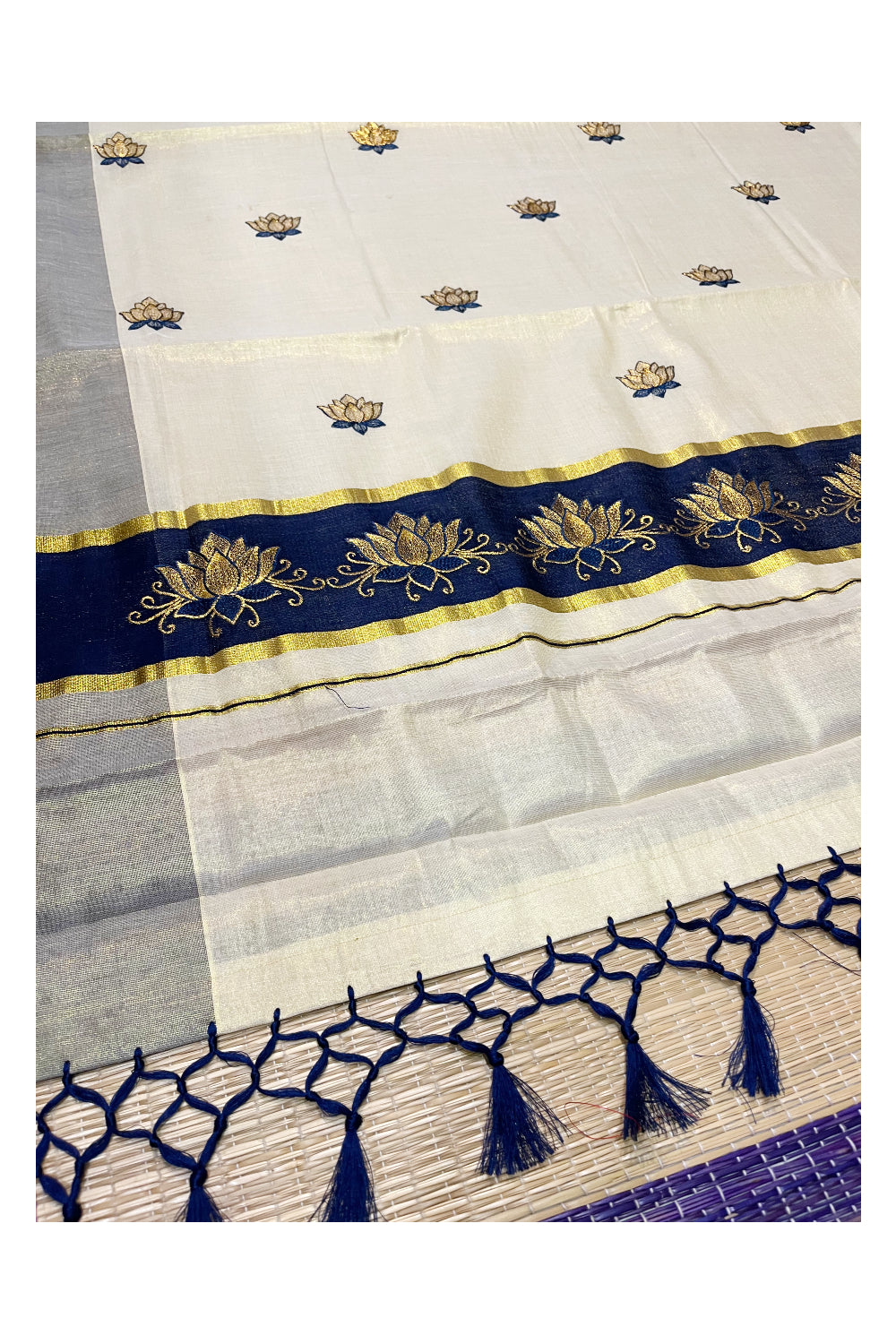 Southloom Kerala Tissue Kasavu Saree with Blue And Golden Lotus Embroidary Designs on Body