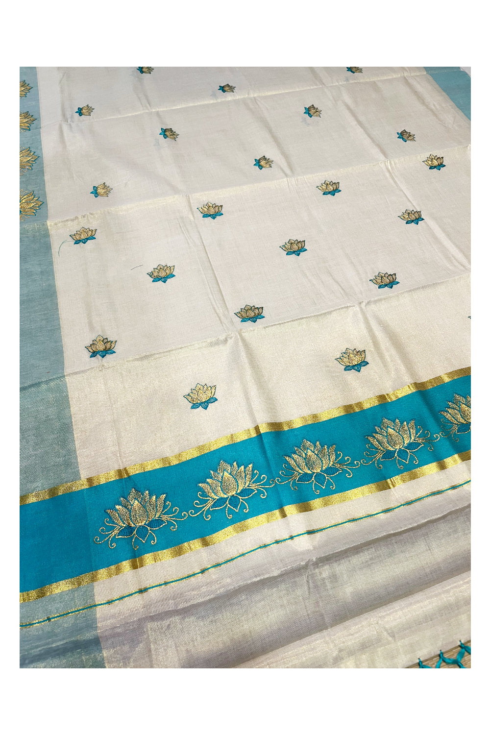 Southloom Kerala Tissue Kasavu Saree with Turquoise And Golden Lotus Embroidary Designs on Body SL273