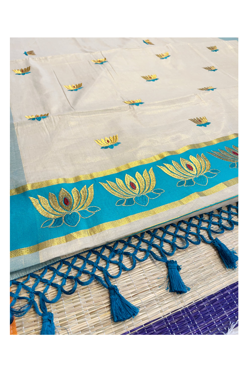 Southloom Kerala Tissue Kasavu Saree with Turquoise And Golden Lotus Embroidary Works on Body
