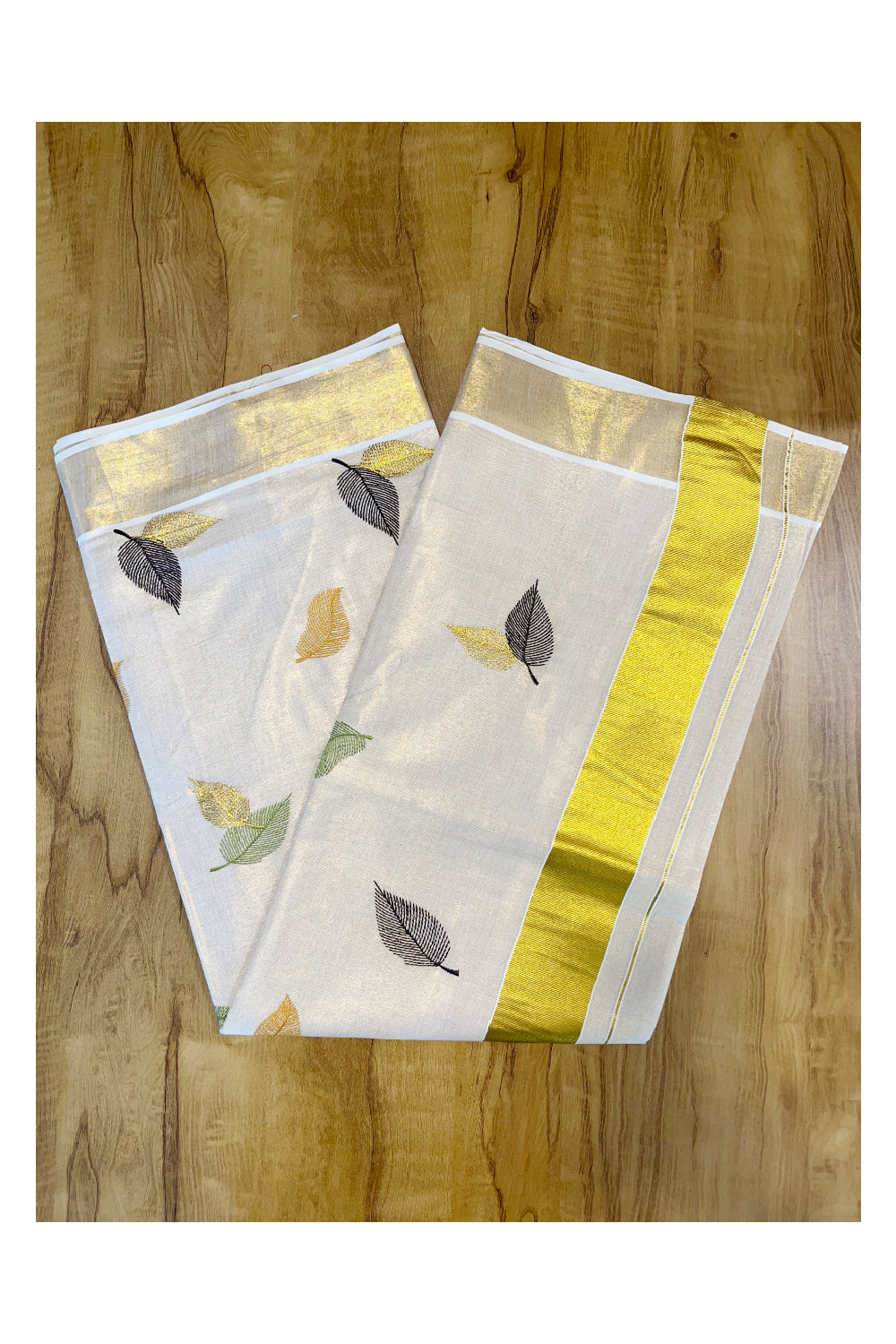Kerala Tissue Kasavu Saree with Green Orange And Brown Leaf Embroidery Works