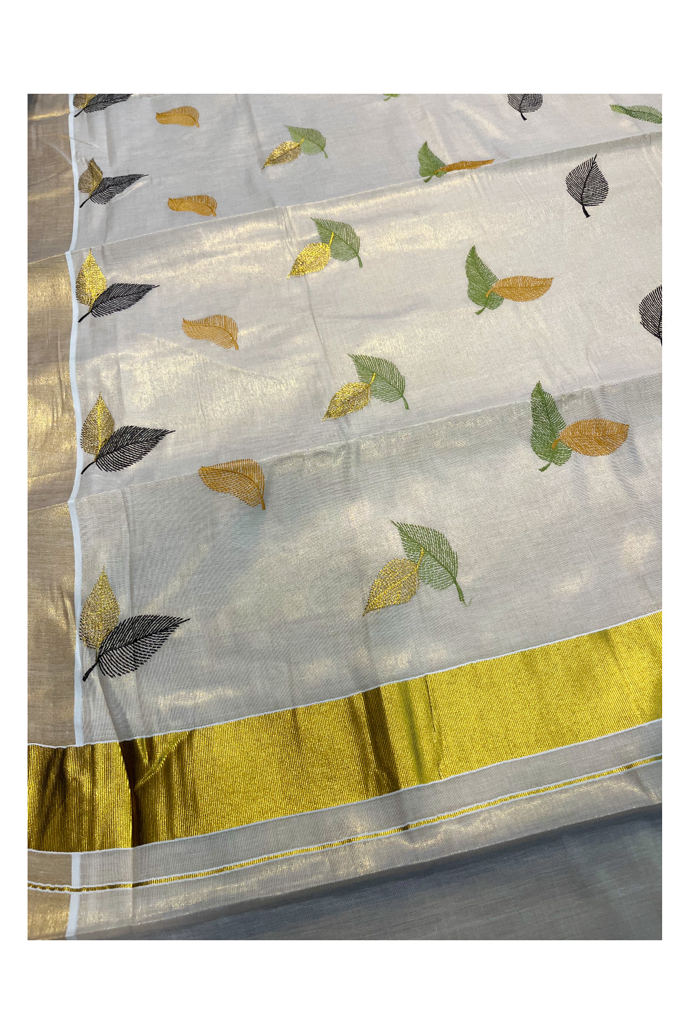 Kerala Tissue Kasavu Saree with Green Orange And Brown Leaf Embroidery Works