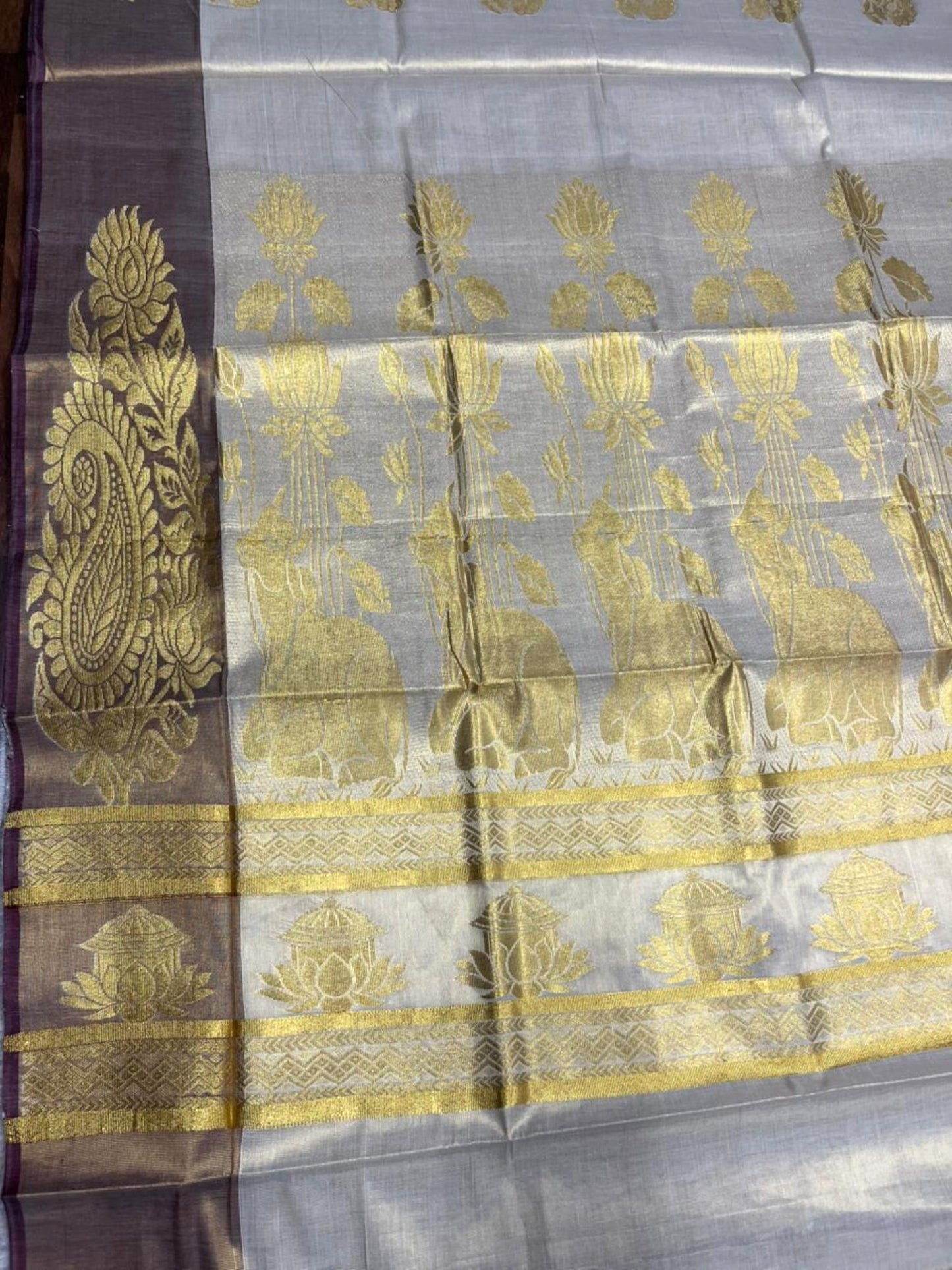 Southloom  Kerala Tissue Kasavu Heavy Work Saree with Nandhi Design And Purple Border SL483