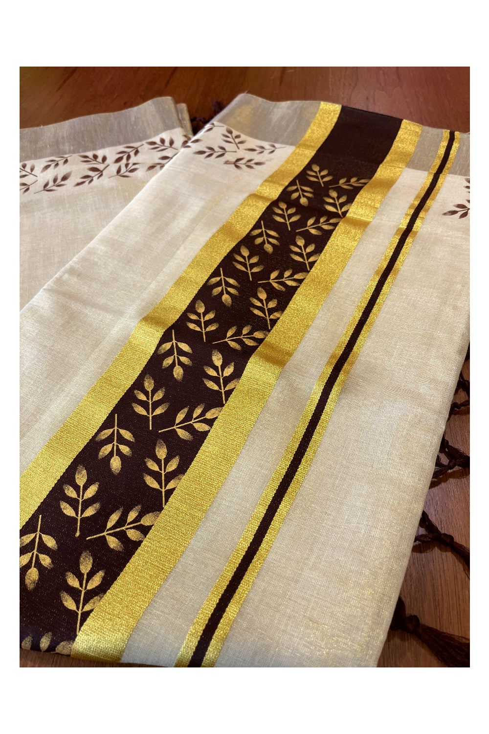 Kerala Tissue Kasavu Saree with Golden and Brown Block Prints on Border and Tassels Works