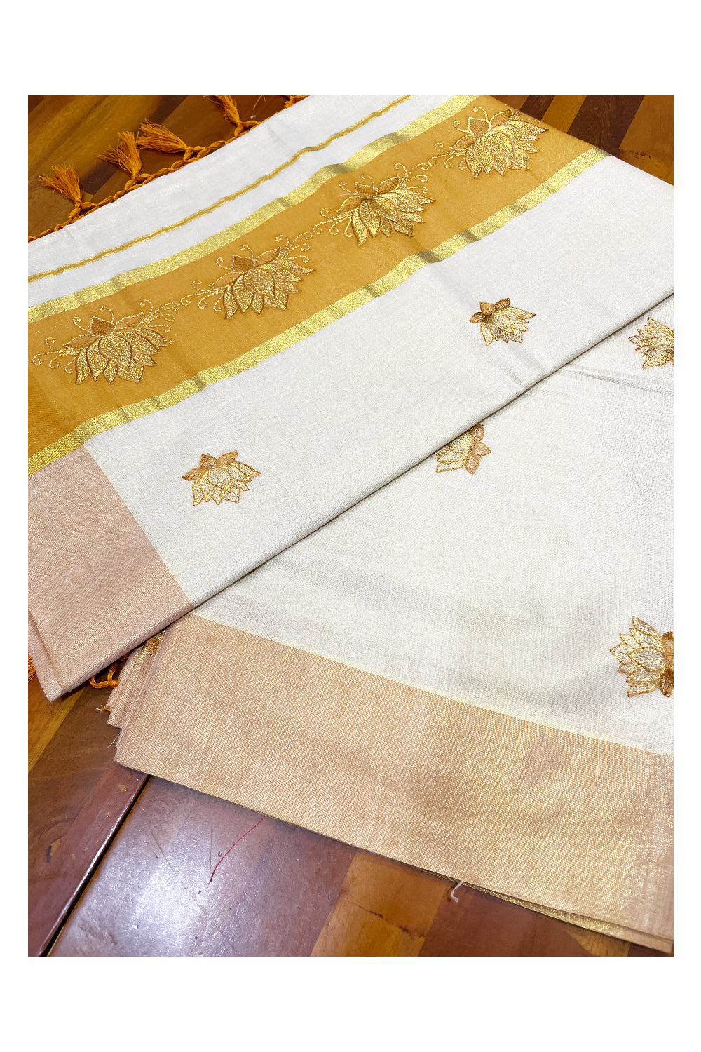 Southloom Kerala Tissue Kasavu Saree with Saffron And Golden Lotus Embroidary Designs on Body