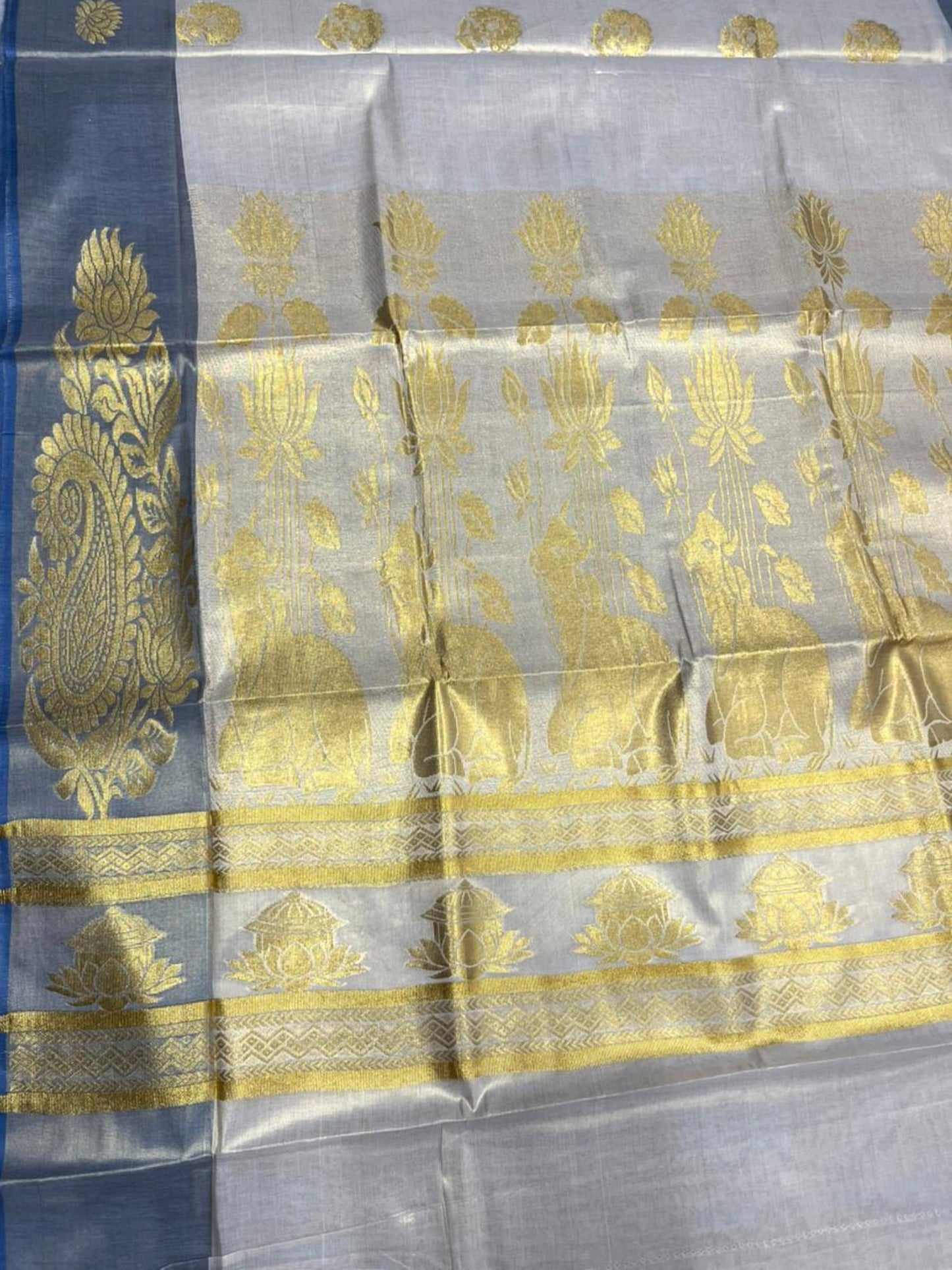 Southloom  Kerala Tissue Kasavu Heavy Work Saree with Floral Design And Blue Border SL483