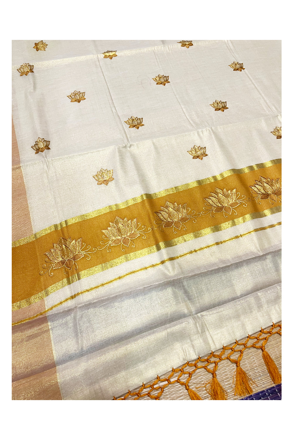 Southloom Kerala Tissue Kasavu Saree with Saffron And Golden Lotus Embroidary Designs on Body