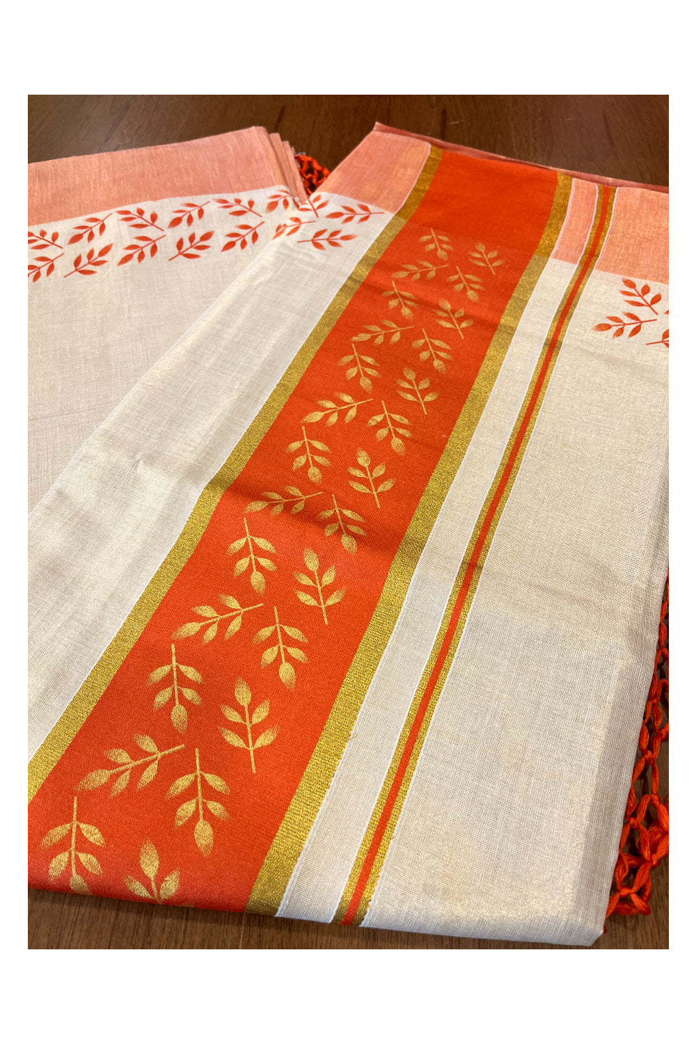 Kerala Tissue Kasavu Saree with Golden and Orange Block Prints on Border and Tassels Works