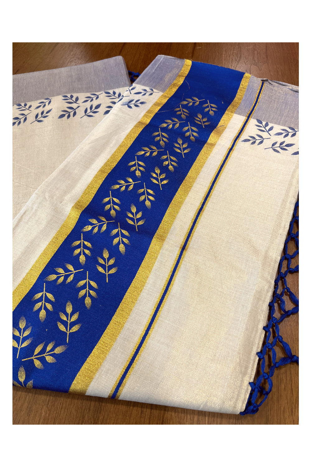 Kerala Tissue Kasavu Saree with Golden and Blue Block Prints on Border and Tassels Works