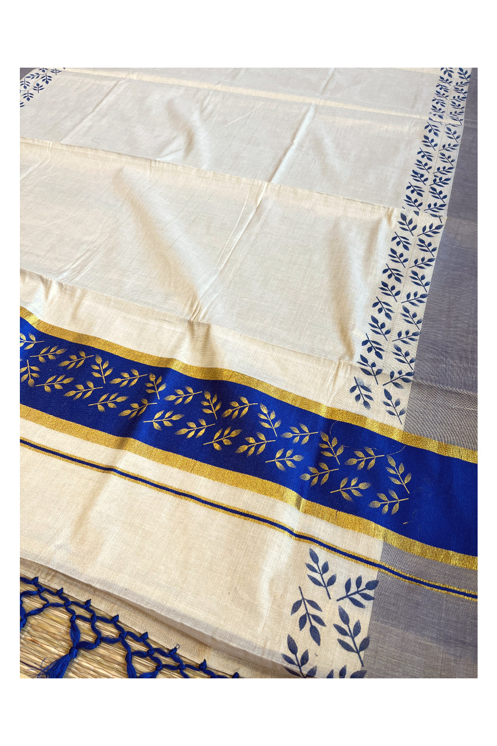 Kerala Tissue Kasavu Saree with Golden and Blue Block Prints on Border and Tassels Works