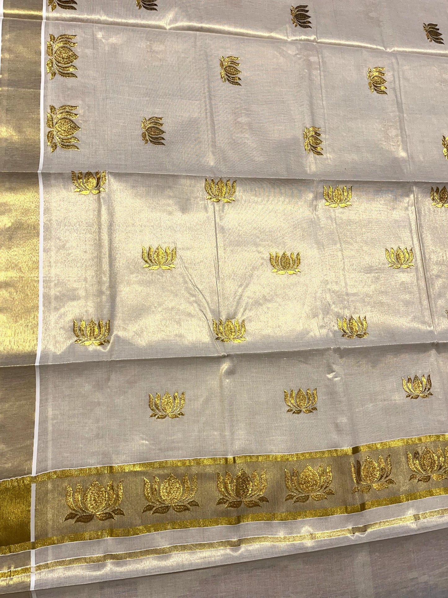 Southloom Tissue Kerala Kasavu Saree with Lotus Embroidery Design