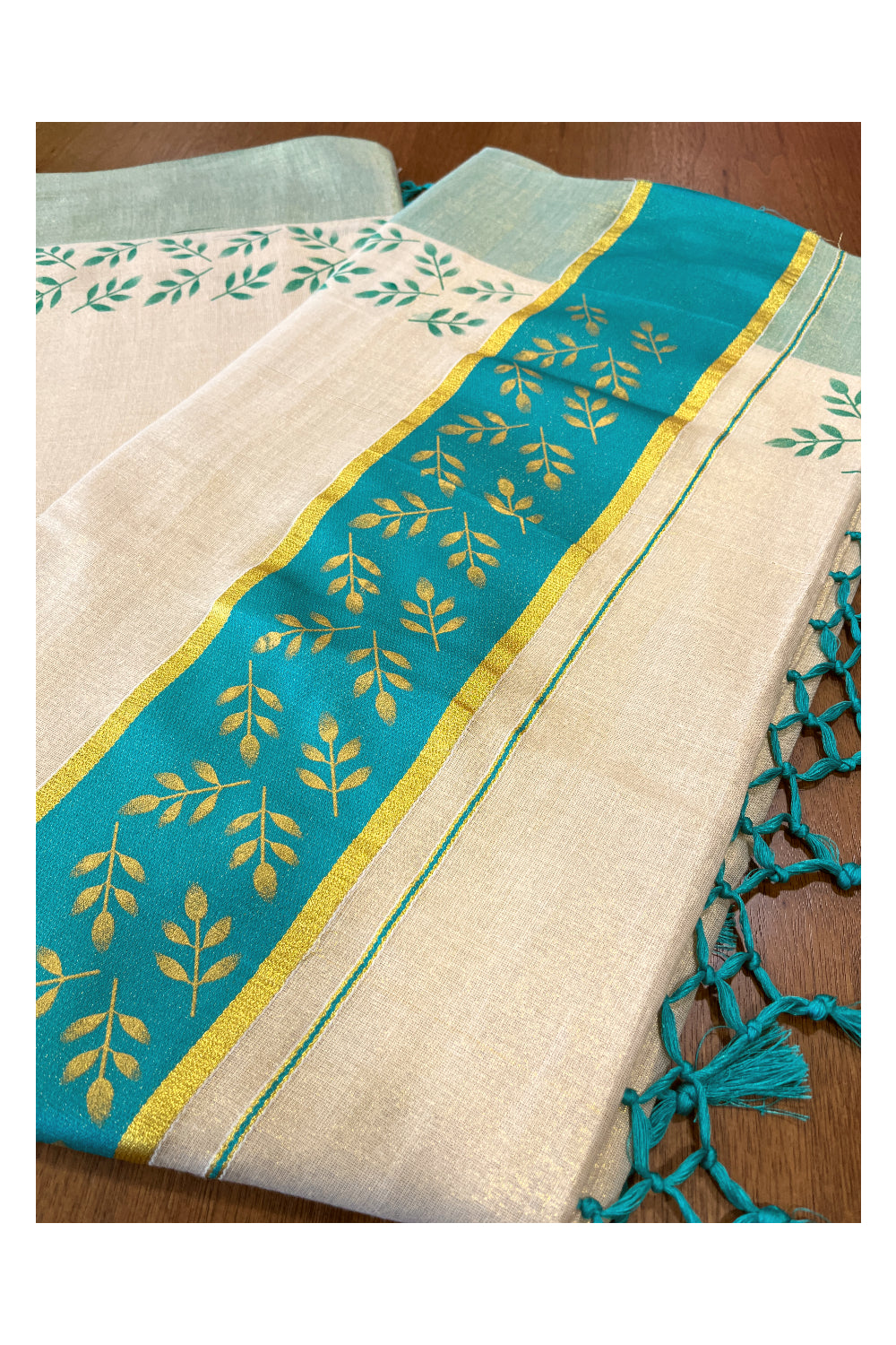 Kerala Tissue Kasavu Saree with Golden and Turquoise Block Prints on Border and Tassels Works