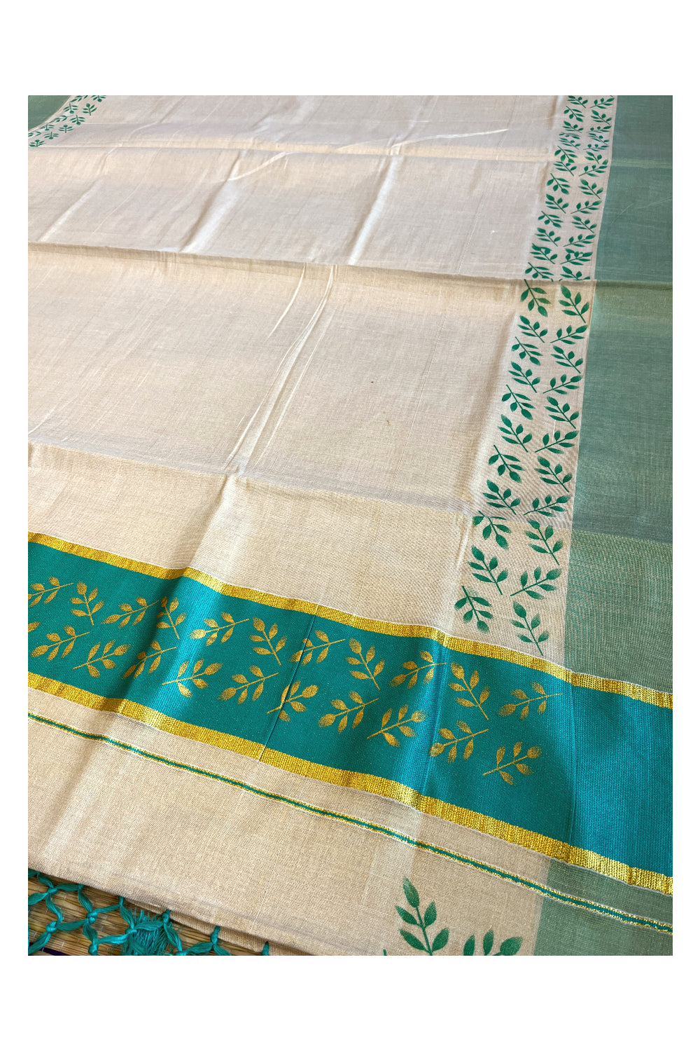 Kerala Tissue Kasavu Saree with Golden and Turquoise Block Prints on Border and Tassels Works