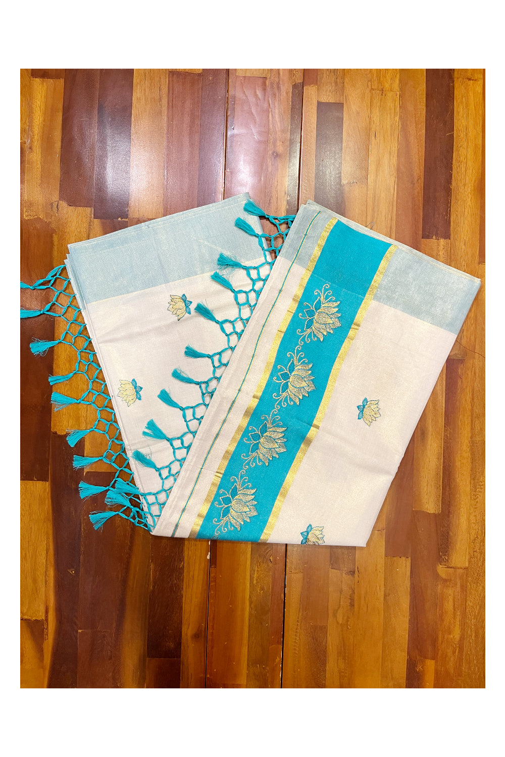 Southloom Kerala Tissue Kasavu Saree with Turquoise And Golden Lotus Embroidary Designs on Body SL273