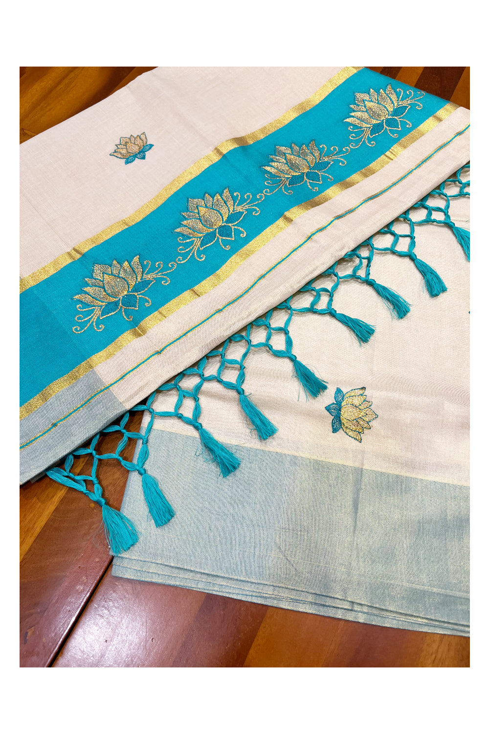 Southloom Kerala Tissue Kasavu Saree with Turquoise And Golden Lotus Embroidary Designs on Body SL273