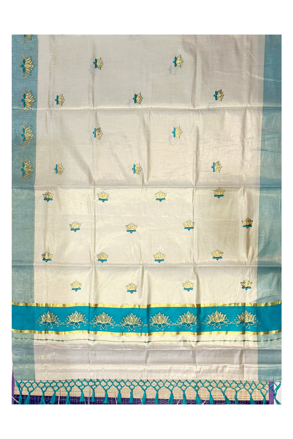Southloom Kerala Tissue Kasavu Saree with Turquoise And Golden Lotus Embroidary Designs on Body SL273