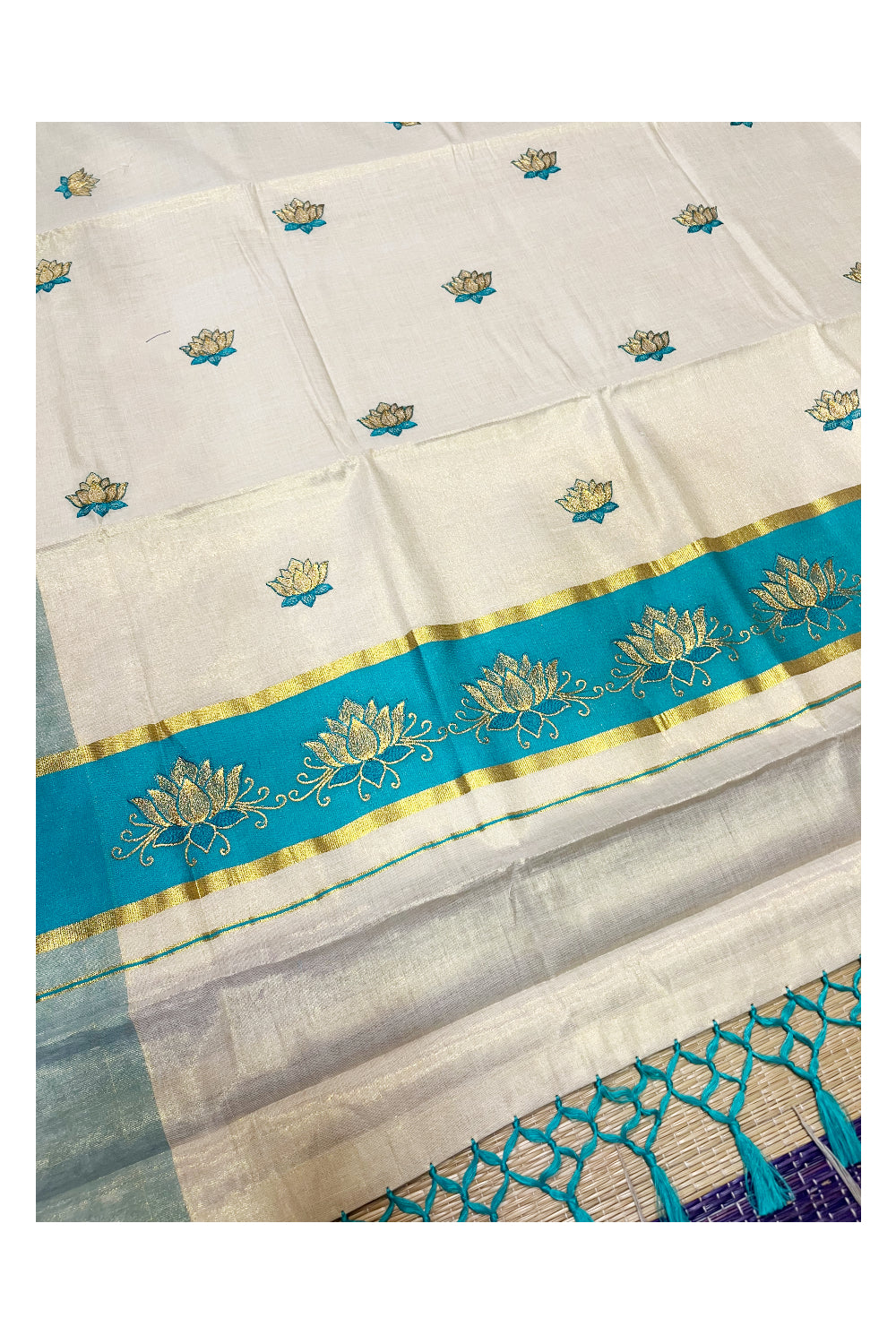 Southloom Kerala Tissue Kasavu Saree with Turquoise And Golden Lotus Embroidary Designs on Body SL273