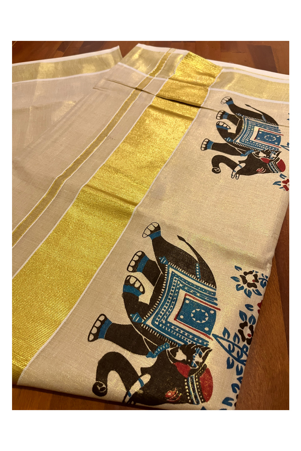 Kerala Tissue Kasavu Saree with Black and Blue Elephant Mural Prints on Border and Pallu