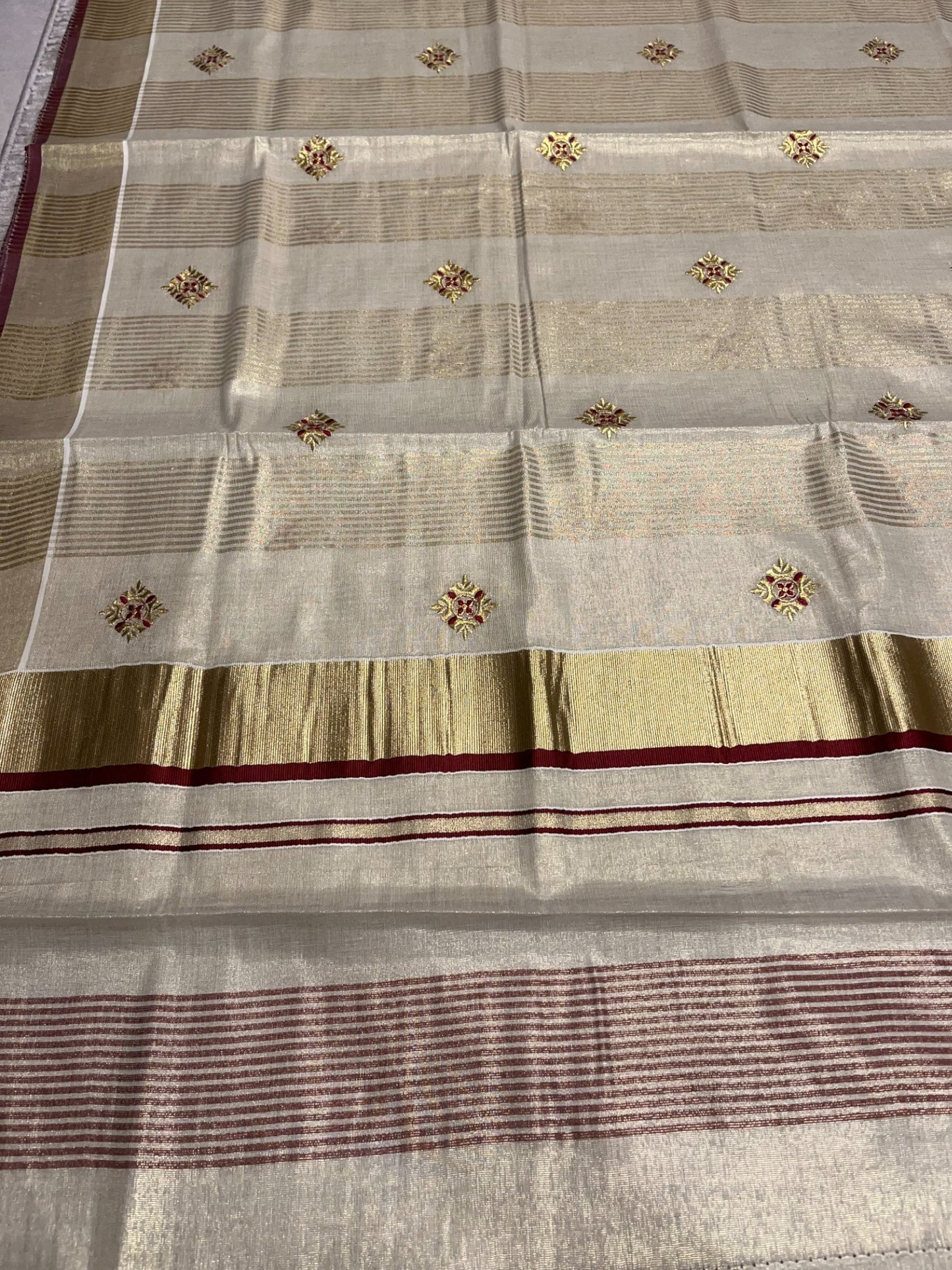 Kerala Tissue Kasavu Lines Saree with Golden And Maroon Embroidery Works