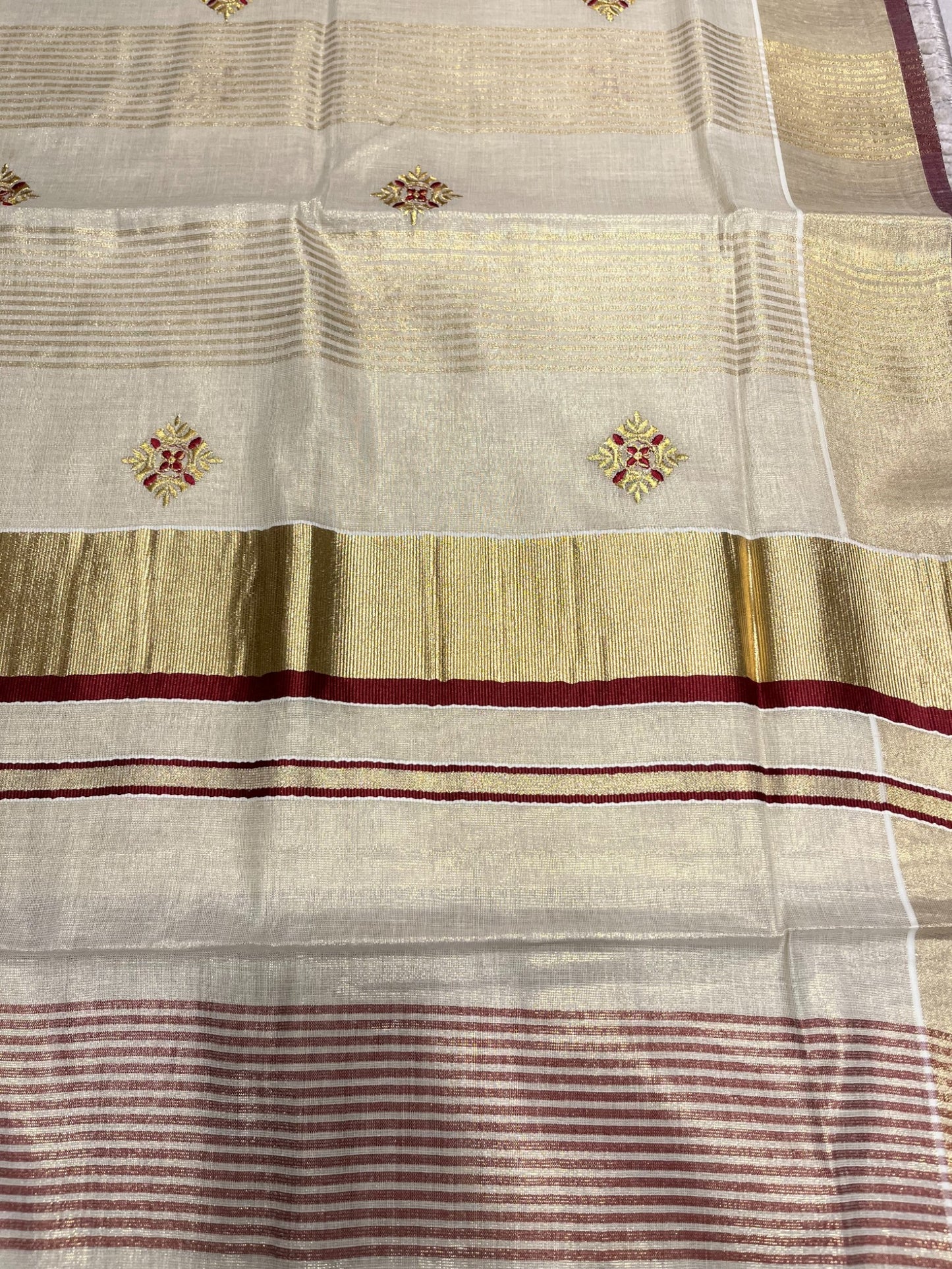 Kerala Tissue Kasavu Lines Saree with Golden And Maroon Embroidery Works