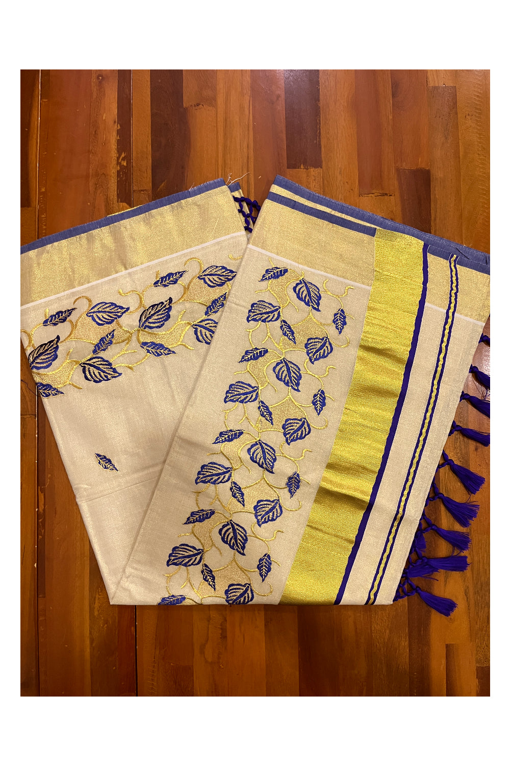 Kerala Tissue Kasavu Heavy Work Saree with Golden and Blue Leaf Embroidery Design