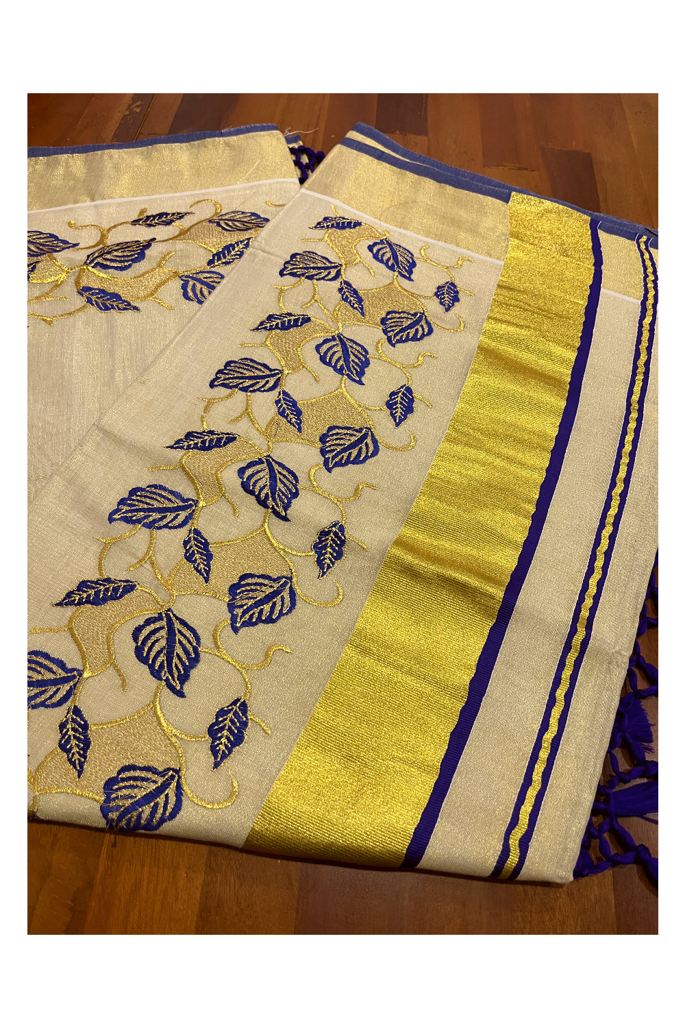 Kerala Tissue Kasavu Heavy Work Saree with Golden and Blue Leaf Embroidery Design