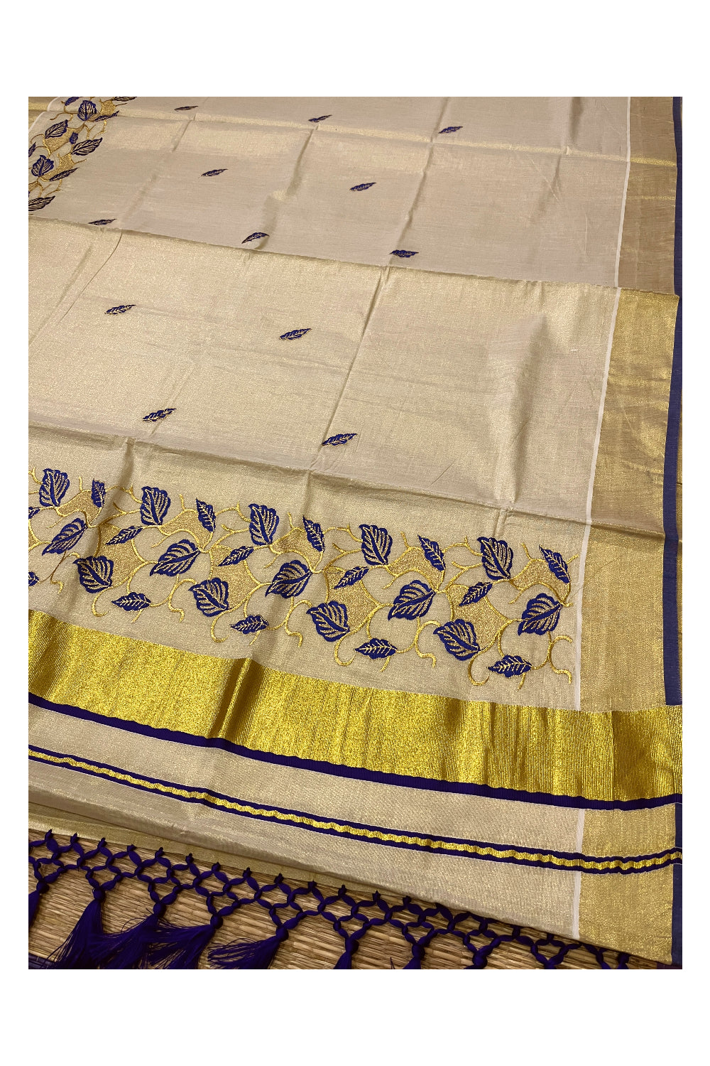 Kerala Tissue Kasavu Heavy Work Saree with Golden and Blue Leaf Embroidery Design