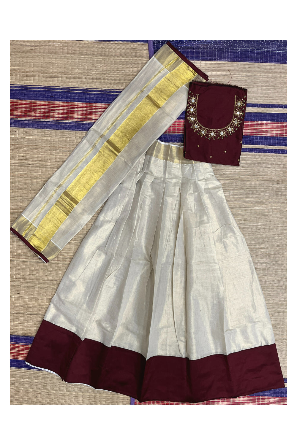 Semi Stitched Onam 2023 Dhavani Set with Tissue Pavada and Maroon Mirror Bead Work Blouse Piece