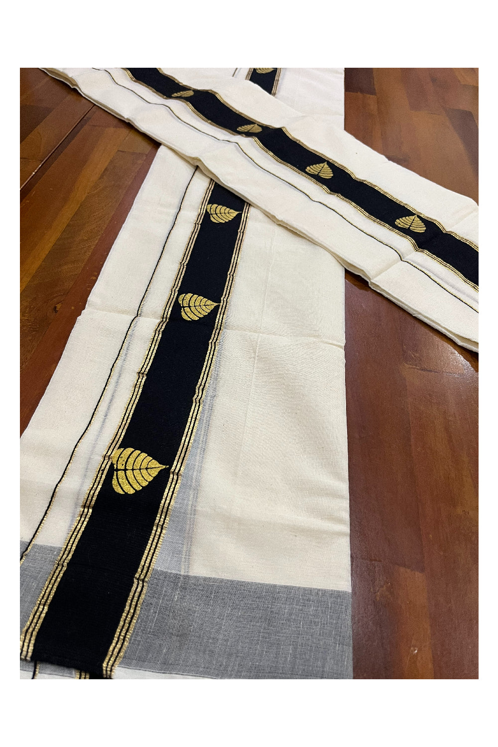 Cotton Single Set Mundu (Mundu Neriyathum) with Golden Leaf Block Prints on Black Border (Onam Set Mundu 2023)