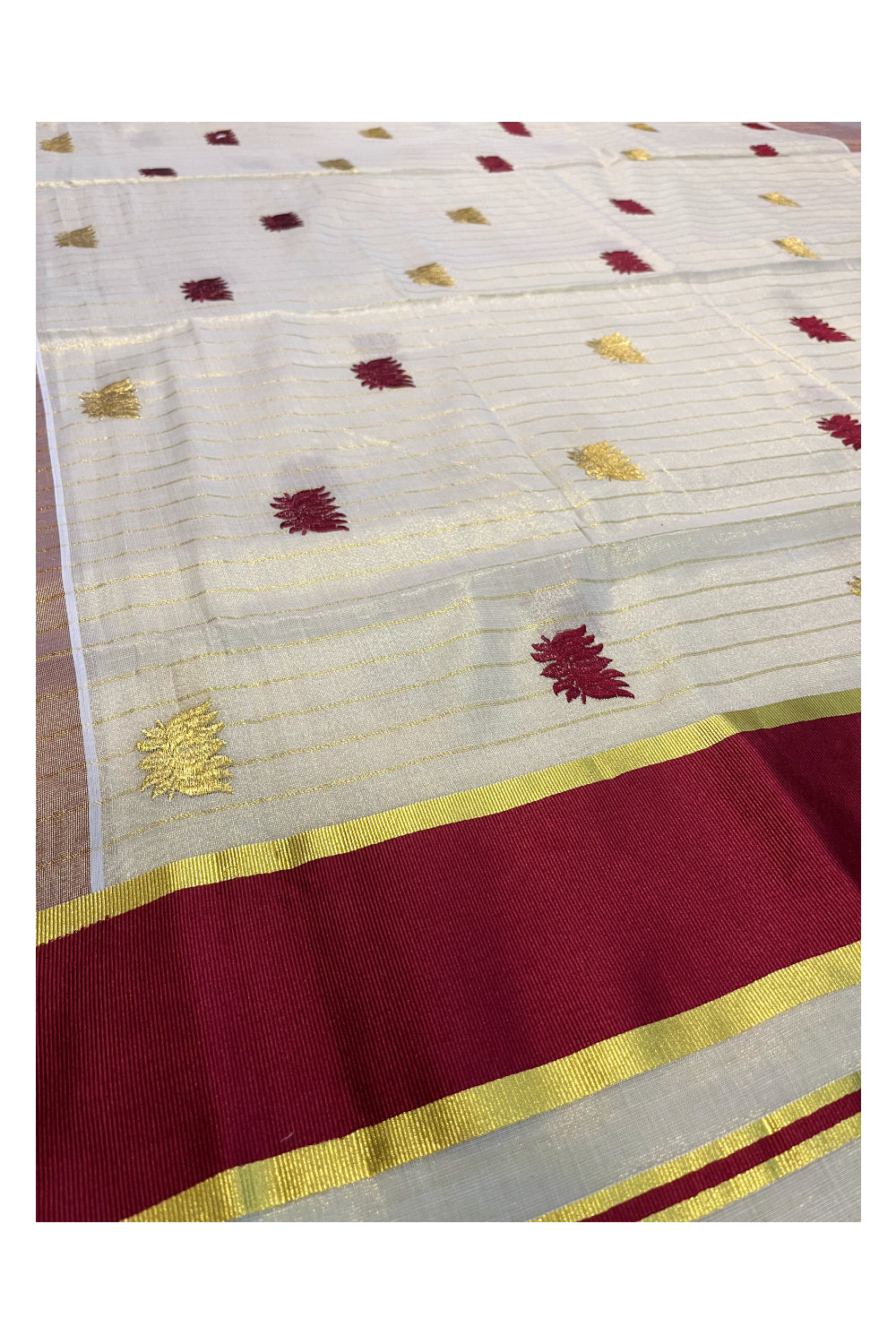 Kerala Tissue Kasavu Lines Saree with Maroon And Golden Lotus Embroidery Works