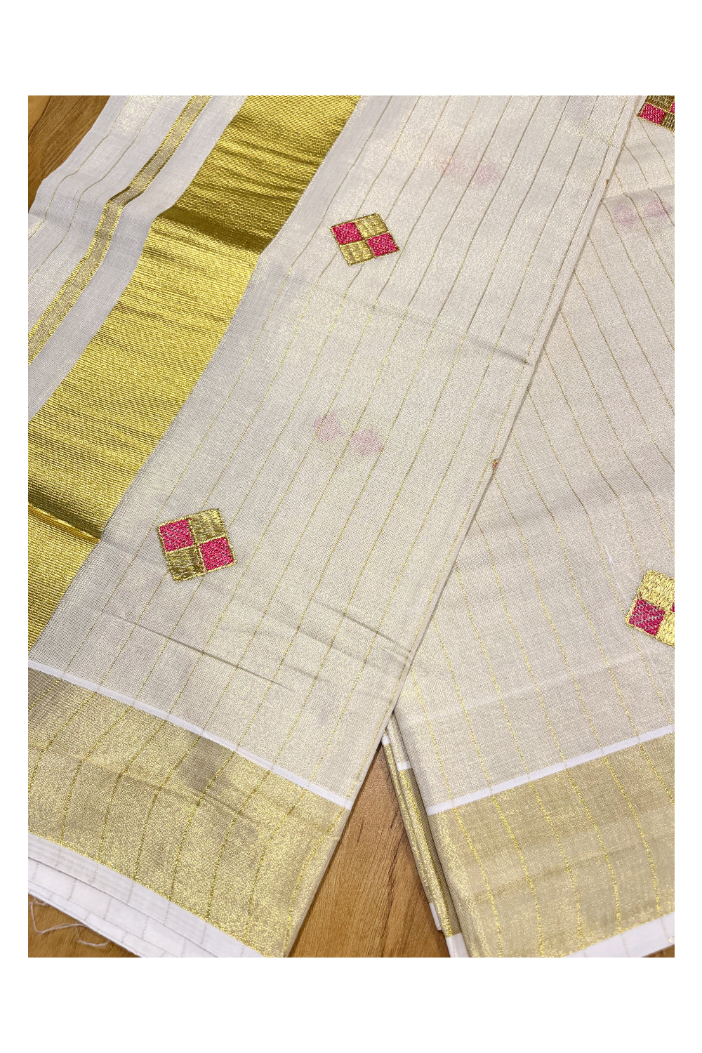 Kerala Tissue Kasavu Stripes Saree with Pink and Golden Diagonal Floral Embroidery Design on Body