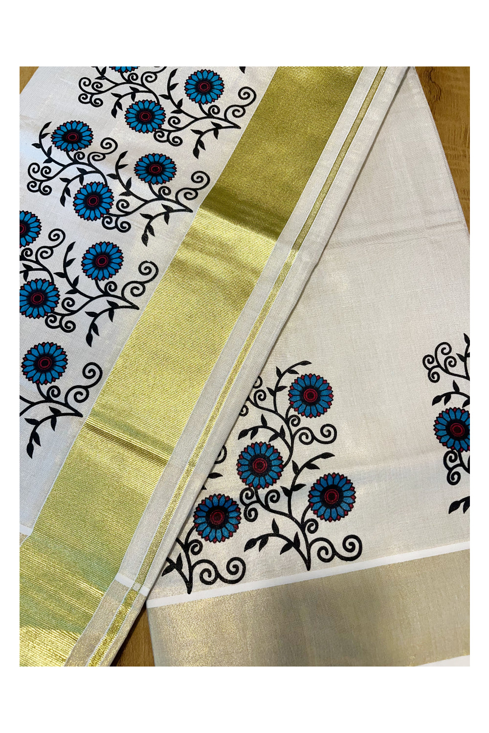 Kerala Tissue Kasavu Saree with Blue And Black Floral Prints On Border