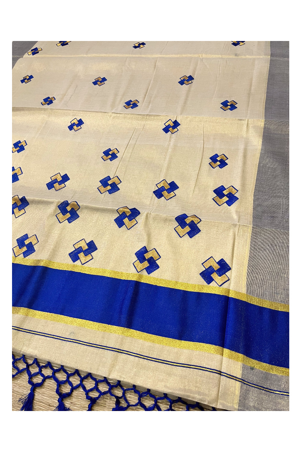 Kerala Tissue Kasavu Saree With Blue Border and Embroidered Designs on Body