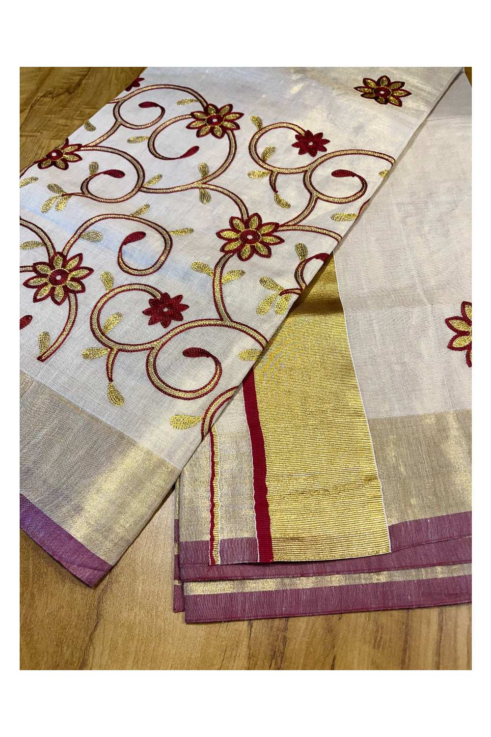 Kerala Tissue Kasavu Saree With Maroon and Golden Floral Embroidery Works