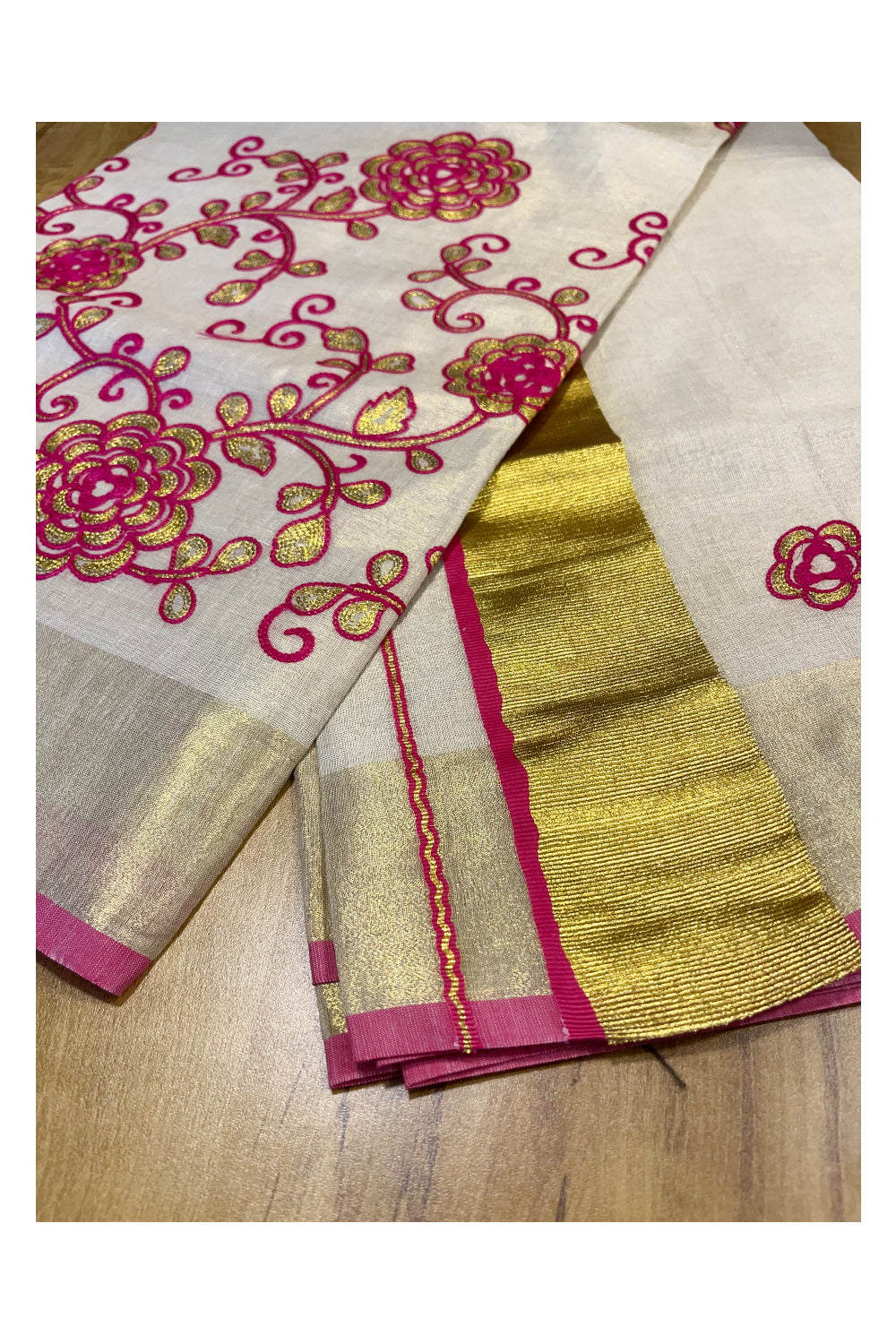 Kerala Tissue Kasavu Saree With Pink and Golden Floral Embroidery Works