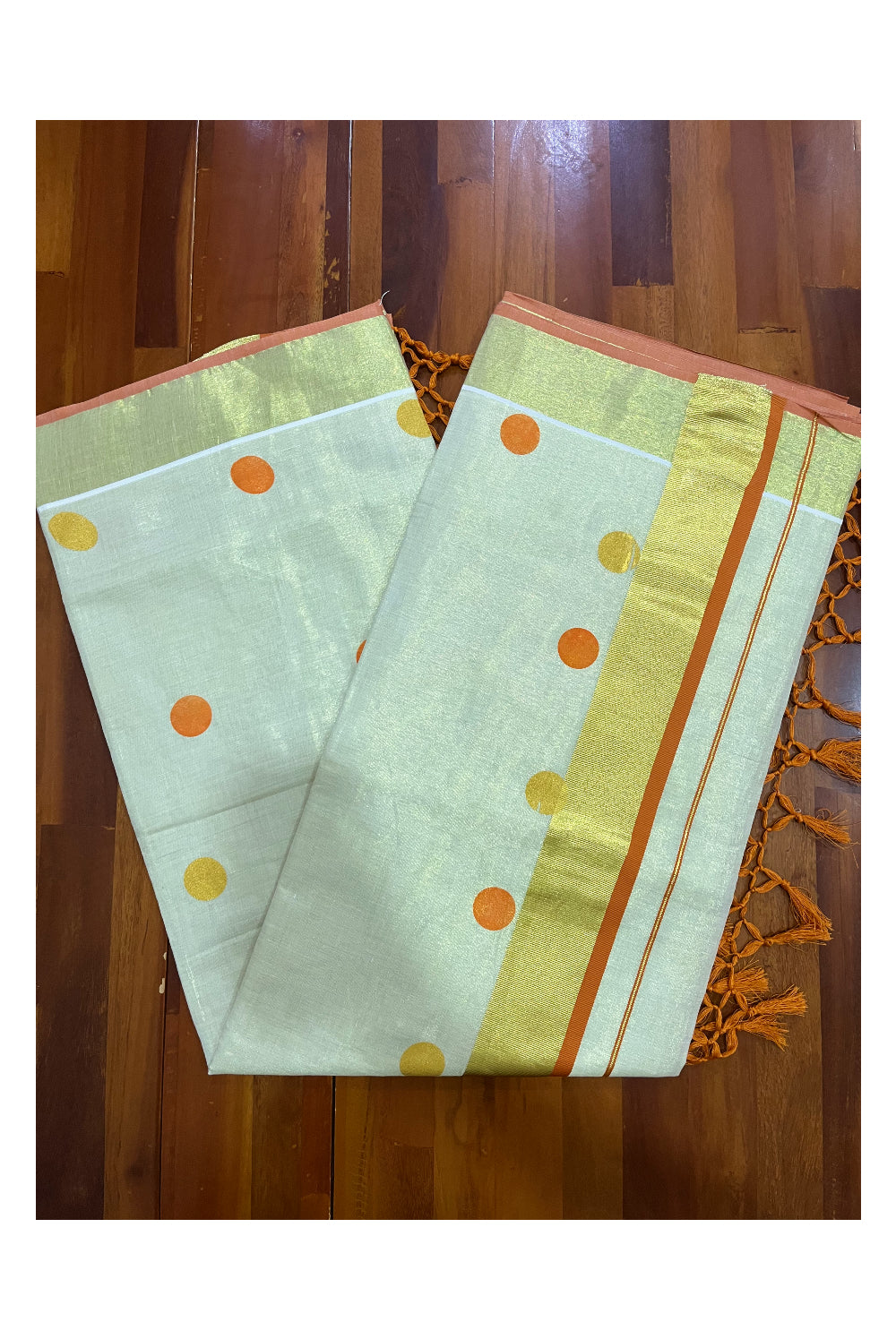 Kerala Tissue Kasavu Saree with Orange and Golden Polka Prints and Tassels Works