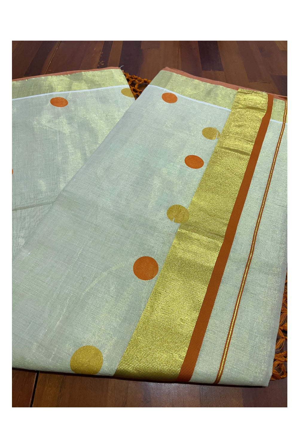 Kerala Tissue Kasavu Saree with Orange and Golden Polka Prints and Tassels Works