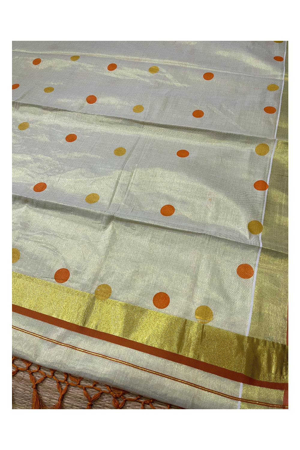 Kerala Tissue Kasavu Saree with Orange and Golden Polka Prints and Tassels Works