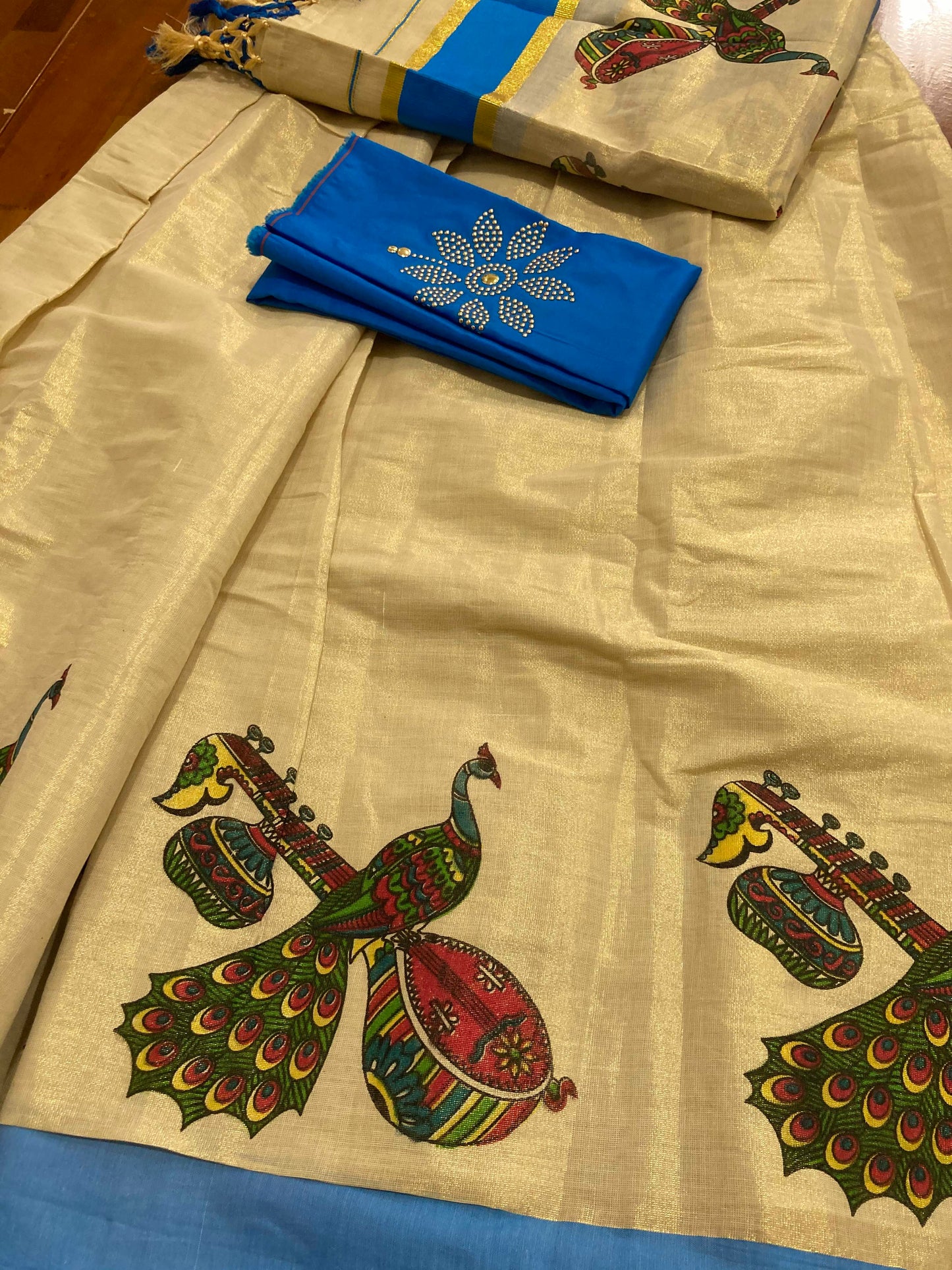 Kerala Tissue Stitched Dhavani Set with Blouse Piece and Neriyathu in with Light Blue Accents and Mural Designs