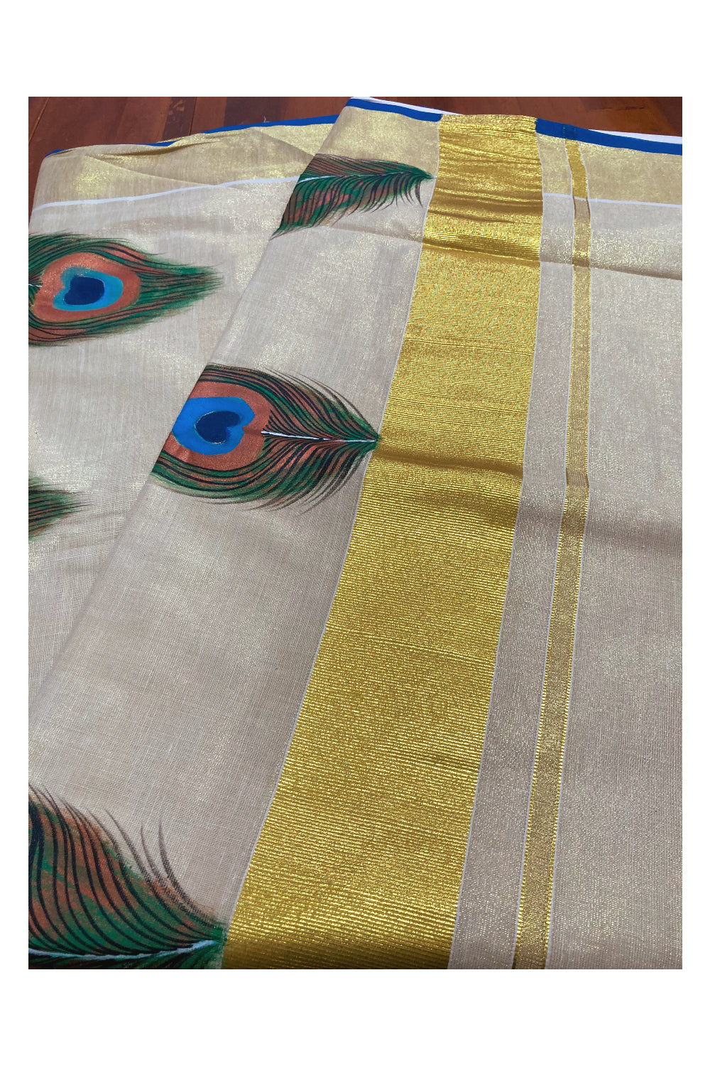 Kerala Tissue Kasavu Saree with Hand Painted Feather Design and Blue on Border