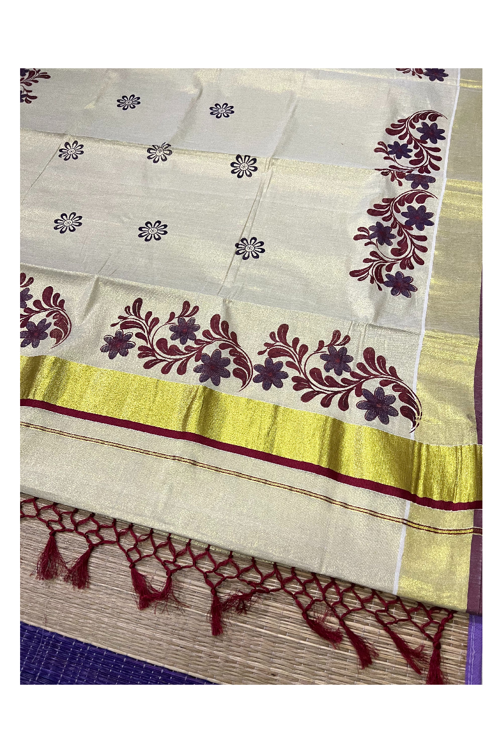 Kerala Tissue Kasavu Saree with Maroon Violet Mural Floral Design and Tassels on Pallu