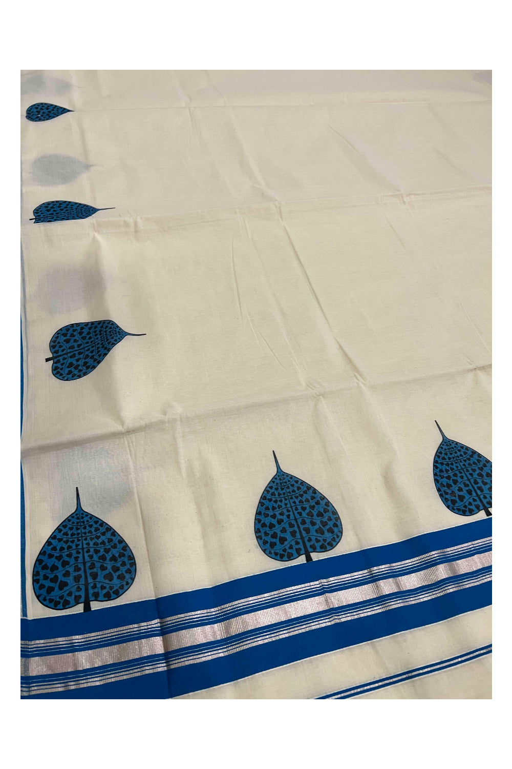 Pure Cotton Kerala Silver Kasavu and Light Blue Border Saree with Mural Leaf Prints