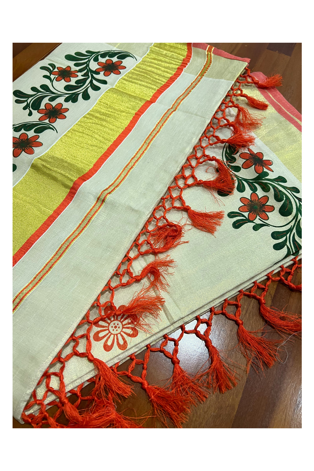 Kerala Tissue Kasavu Saree with Orange Dark Green Mural Floral Design and Tassels on Pallu