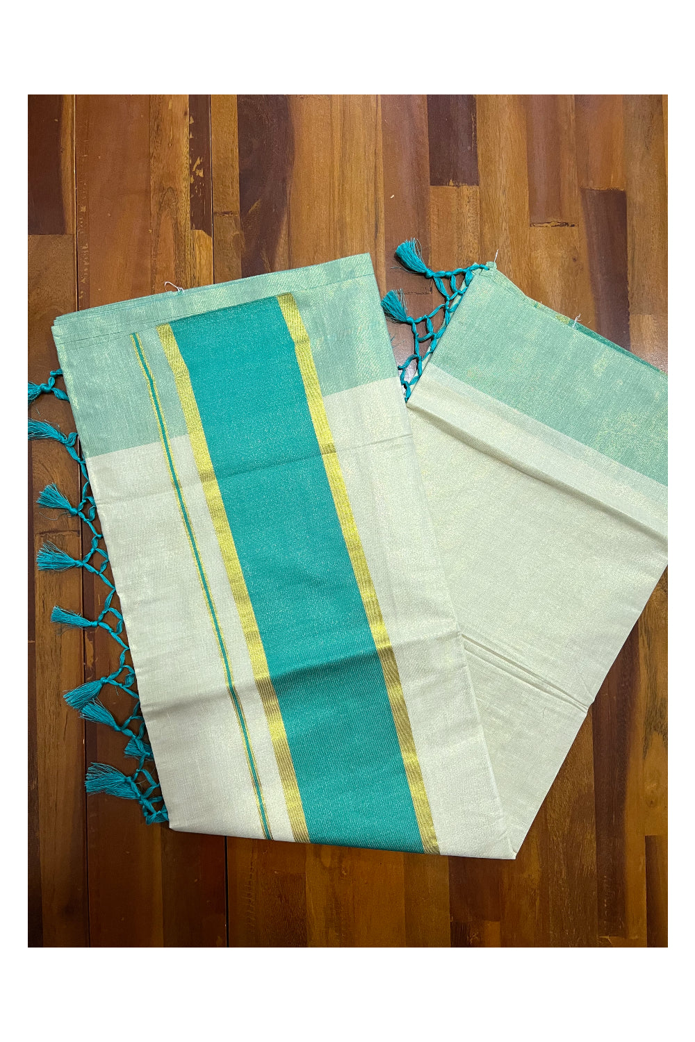 Kerala Kasavu Tissue Plain Saree with Turquoise and Kasavu Border and Tassels Work on Pallu