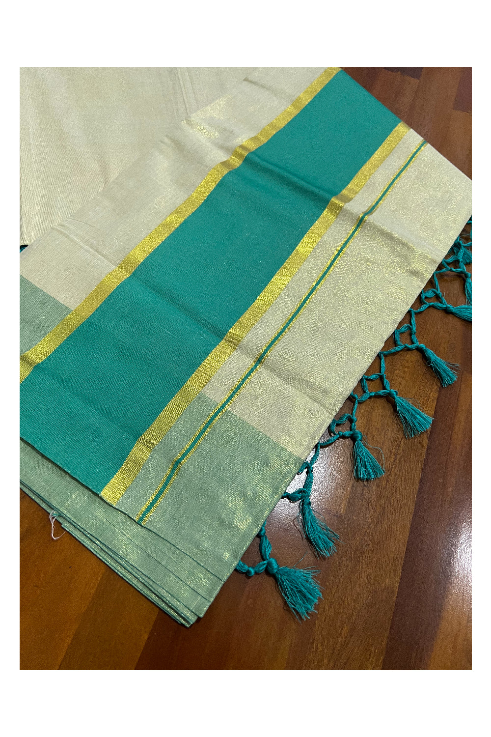 Kerala Kasavu Tissue Plain Saree with Turquoise and Kasavu Border and Tassels Work on Pallu