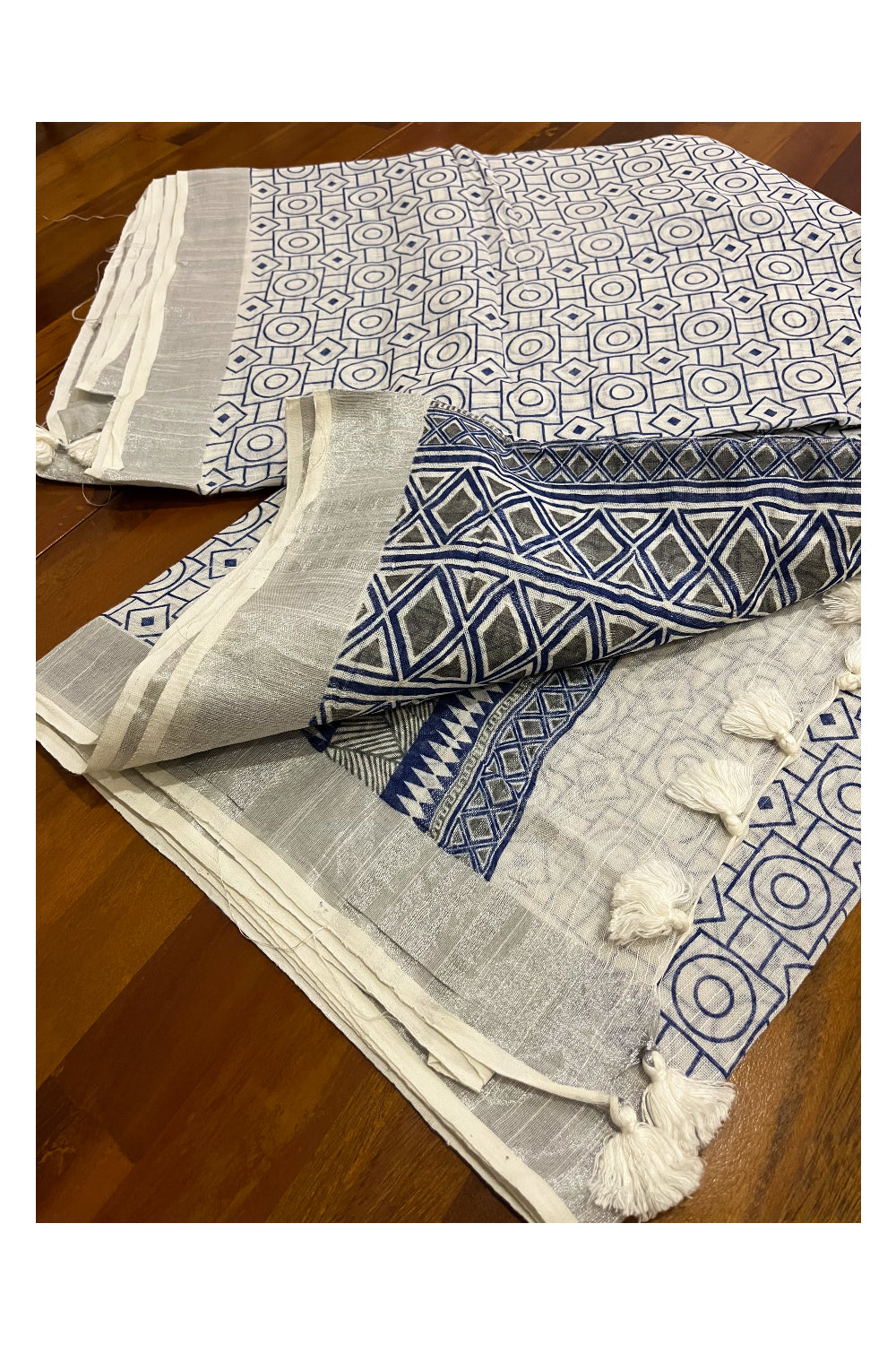 Southloom Linen Designer Saree in Blue Prints on White Body with Tassels and Ikkat Blouse Piece