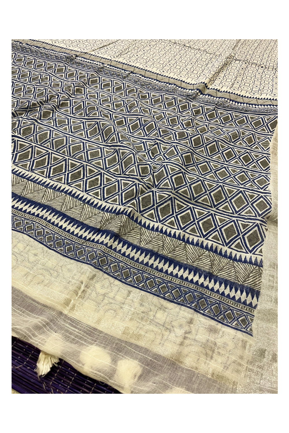 Southloom Linen Designer Saree in Blue Prints on White Body with Tassels and Ikkat Blouse Piece