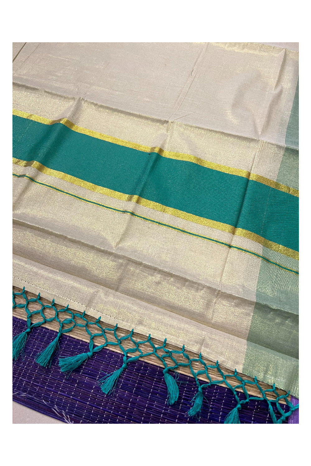 Kerala Kasavu Tissue Plain Saree with Turquoise and Kasavu Border and Tassels Work on Pallu