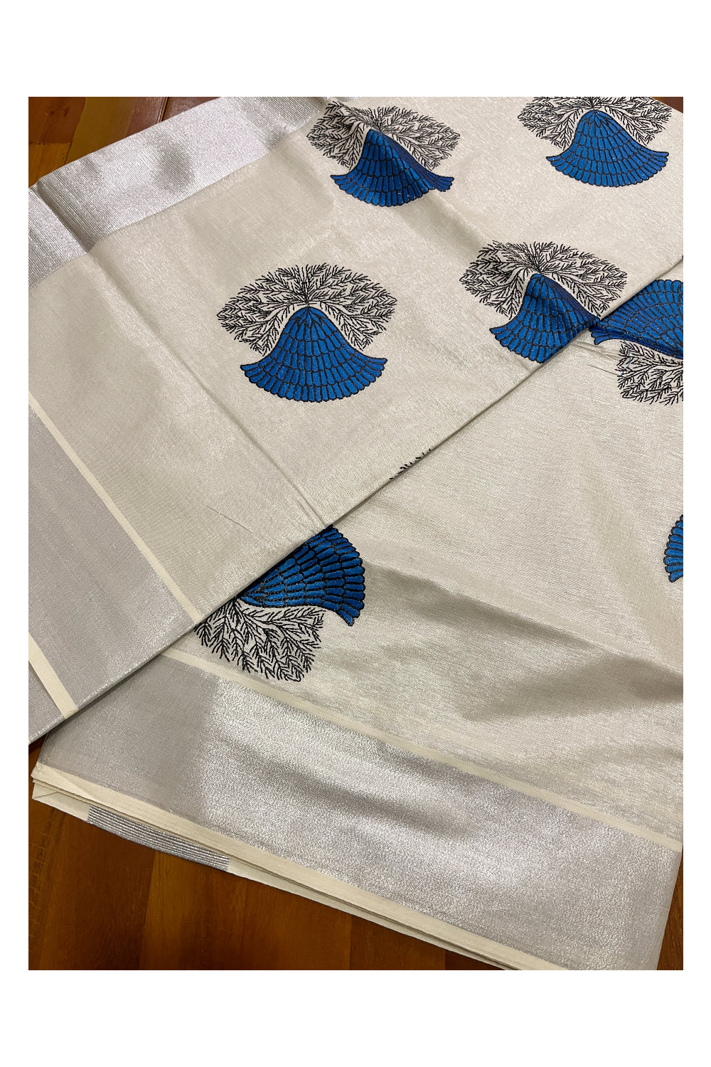 Kerala Silver Tissue Kasavu Saree with Blue Floral Embroidery Design