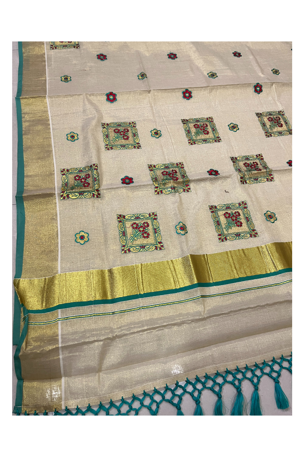 Kerala Tissue Kasavu Heavy Work Saree with Golden and Turquoise Floral Embroidery Design