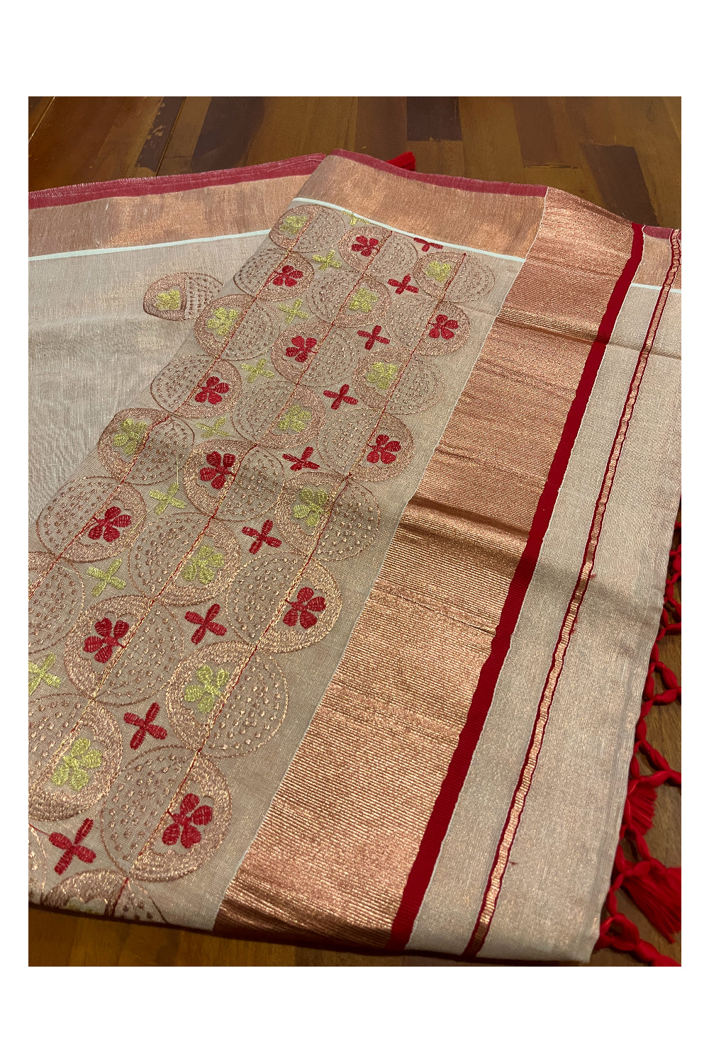 Southloom Copper Tissue Kasavu Saree with Embroidery Design and Red Tassels Works on Pallu